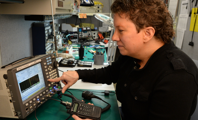 Service technician working on programming radio
