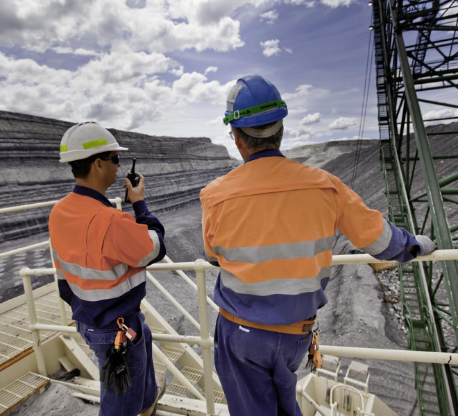 two men coal mine talking on two-way radio